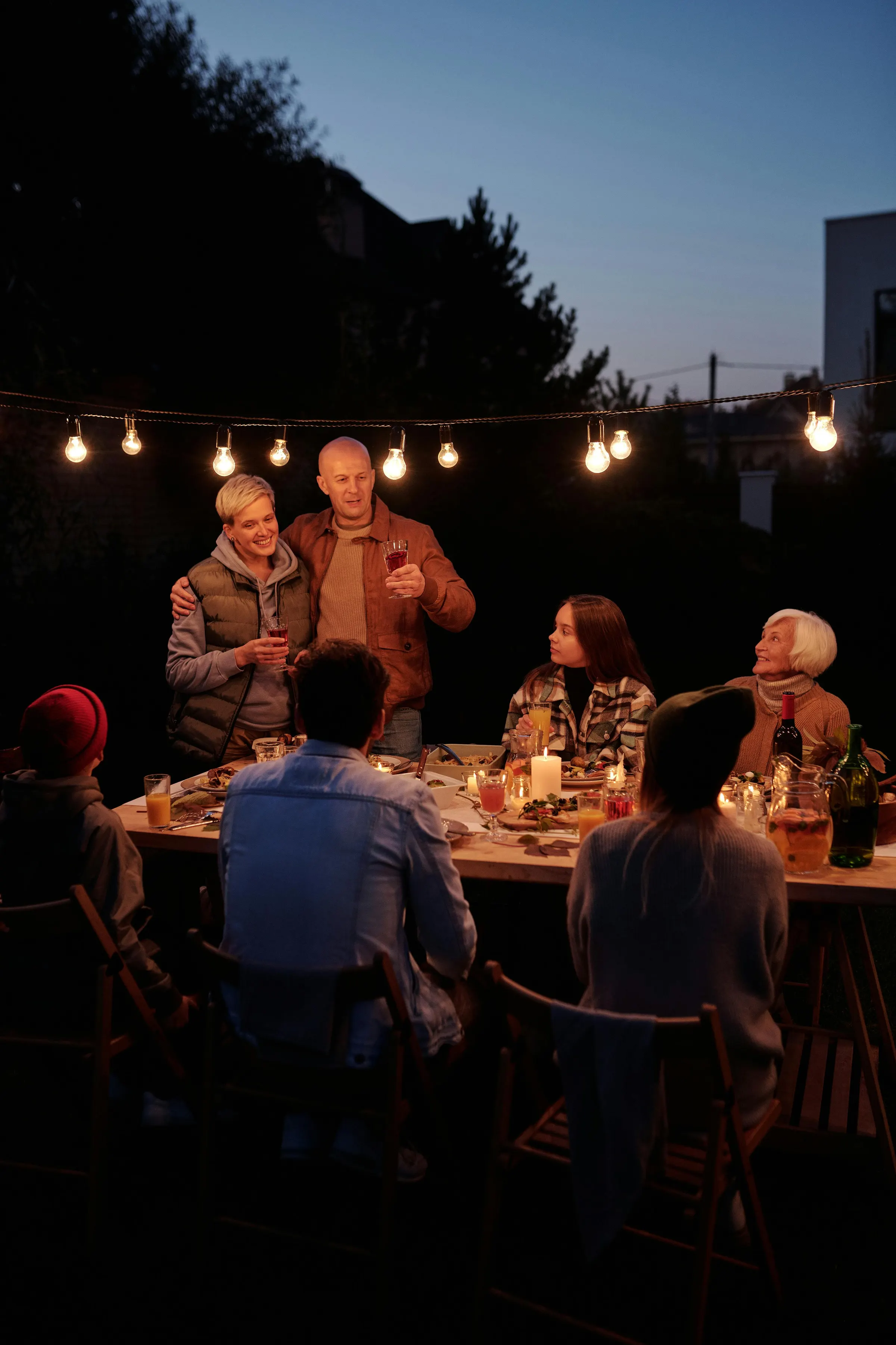 Friends dining outdoors at dusk